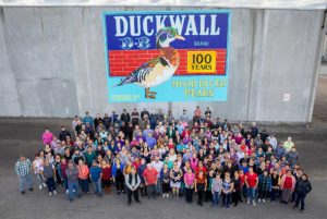 Duckwall Fruit current company staff stands outside their facility in Odell, Oregon, and a new mural celebrating the company’s 100 years of business in the Hood River Valley. (Courtesy Blaine Franger for Duckwall Fruit)