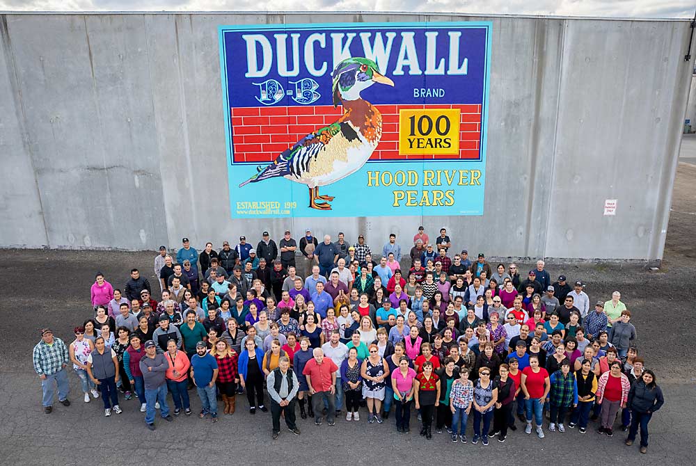 Duckwall Fruit current company staff stands outside their facility in Odell, Oregon, and a new mural celebrating the company’s 100 years of business in the Hood River Valley. <b>(Courtesy Blaine Franger for Duckwall Fruit)</b>
