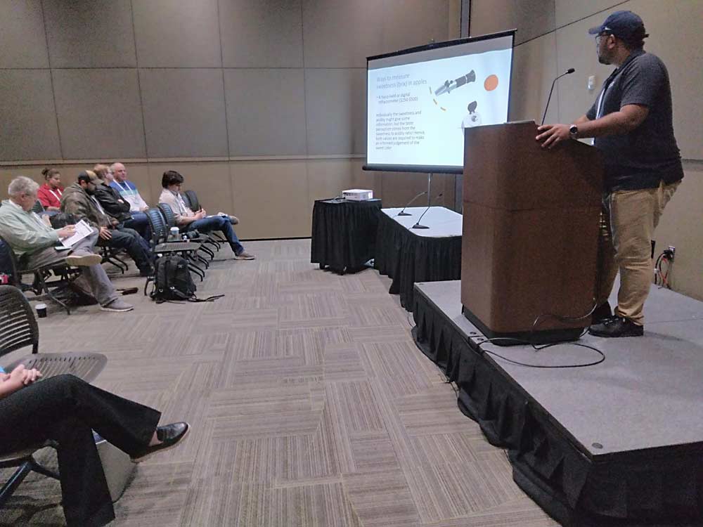 Shanthanu Krishna Kumar, right, Penn State University assistant professor of tree fruit, discusses sweet cider marketing and flavor on Dec. 10 during the 2024 Great Lakes Fruit, Vegetable and Farm Market EXPO in Grand Rapids, Michigan. (Matt Milkovich/Good Fruit Grower)