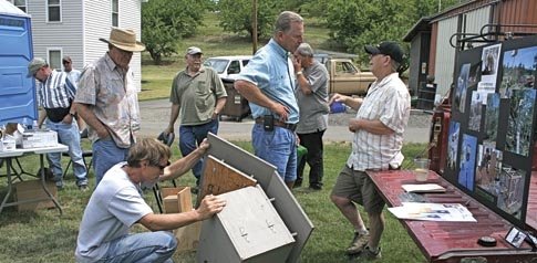 Cabinetmaker Tuck Contreras (right) discusses birdhouses with Dave Case, an orchardist in Chelan, Washington, while Mike Wacker of The Dalles, Oregon, inspects an owl box.