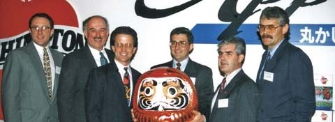 Washington apple industry representatives in Japan in 1995 with a daruma doll. Daruma dolls are traditionally used as good luck symbols.  People fill in one eye of the daruma when they have a wish, and fill in the other when the wish comes true. Pictured 