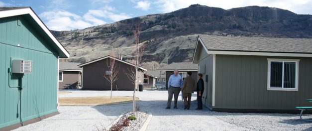 Mike Gempler (facing camera) tours Sage Bluff housing project.