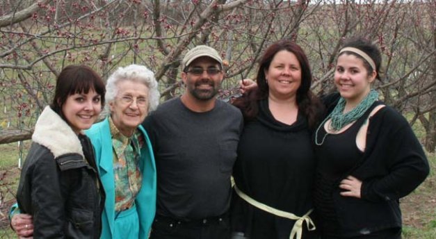 Harry and Jackie Hoch (center) gather in their orchard for a family photo on Easter weekend, where unusual 80-degree weather advanced the season, requiring sprays for disease control on the apricots and plums. With them are Harry’s mother, Jackie Senior, and their daughters Missy (far left) and Angi.