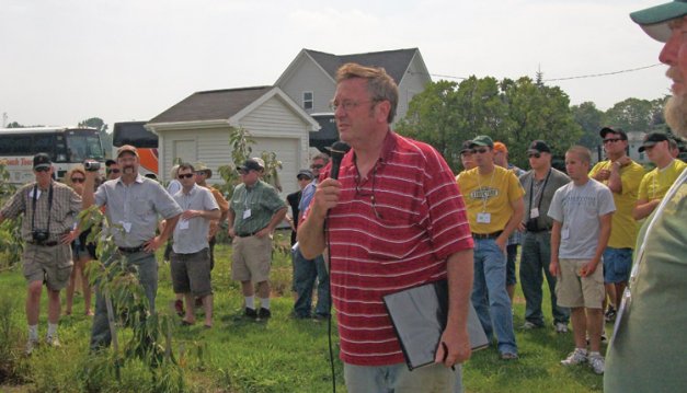 Jim Bittner, pictured with a tour group in his New York orchard, pulled out 20 acres of peaches when a plum pox-positive tree was found in his orchard. He is worried about Canada dropping  its eradication effort.