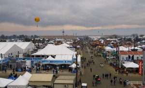 The opening-morning crowd at the 59th annual World Ag Expo braves a forecast calling for rain to explore the show on Tuesday, Feb. 10 in Tulare, California. (Kate Prengaman/Good Fruit Grower)
