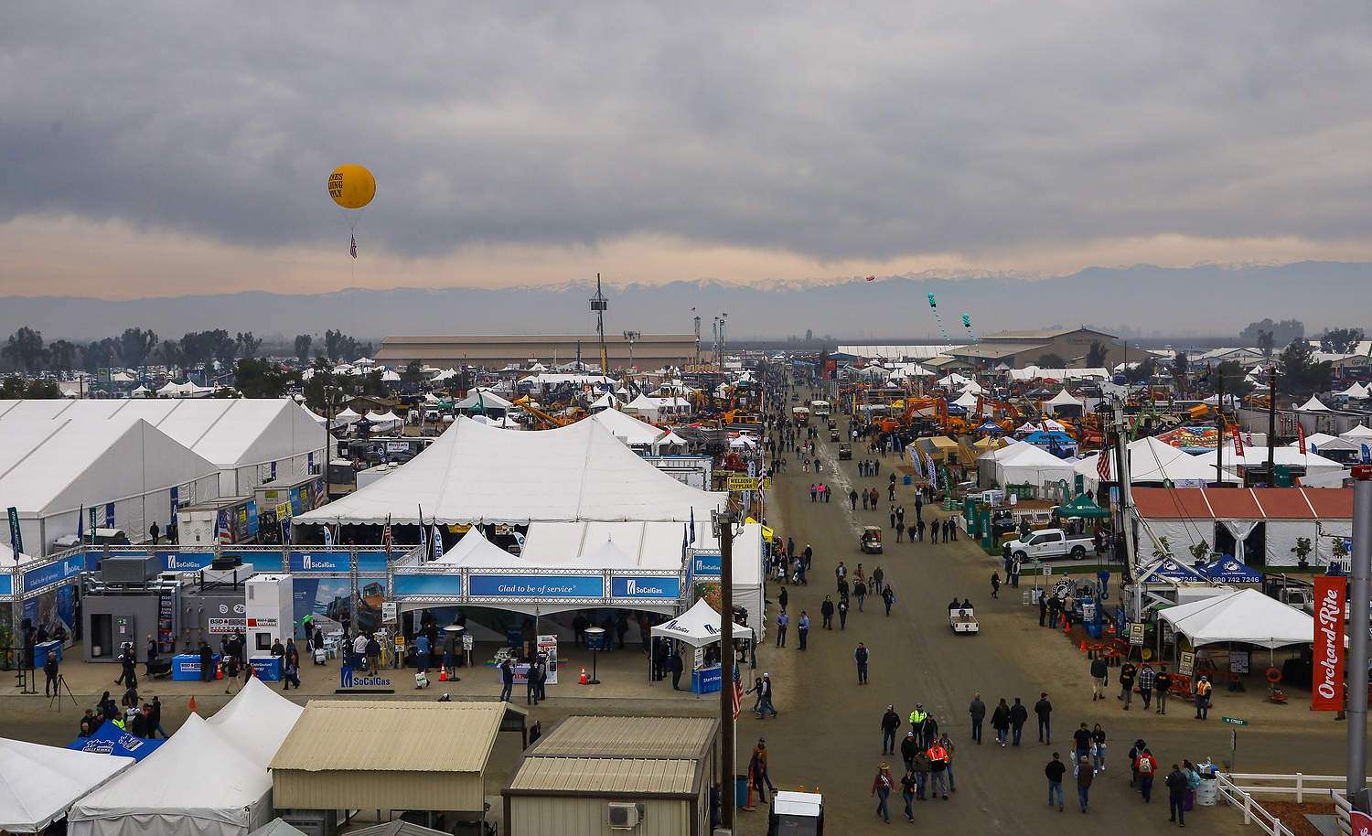 The opening-morning crowd at the 59th annual World Ag Expo braves a forecast calling for rain to explore the show on Tuesday, Feb. 10 in Tulare, California. (Kate Prengaman/Good Fruit Grower)