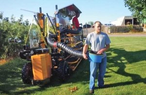 Andrew Duffy, a Phil Brown Welding employee, demonstrates the DBR Conveyor’s new pivoting, plastic bucket, designed to reduce worker strain. (Courtesy Phil Brown Welding)