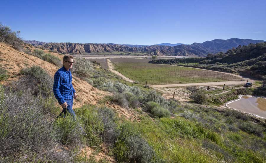 A tour of Byron Albano’s orchards in California’s Cuyama Valley in March. The orchards rest high in the Sierra Madre Mountains, across a dry riverbed leading out of Los Padres National Forest. <b srcset=