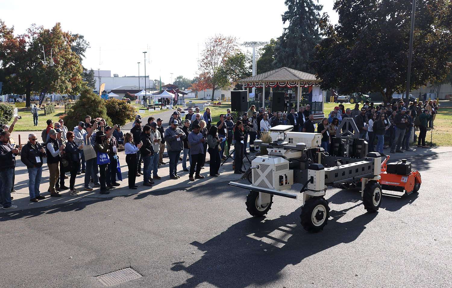 An autonomous robot tows a mower at a demonstration in Yakima, Washington
