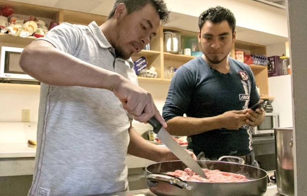 Brothers Daniel, left, and Alberto Morales, tenants of the Brender Creek seasonal farm worker housing facility in Cashmere, Washington, cook dinner Monday, March 28, 2016, after a day of pruning pears near Wenatchee. Whether growers hire domestic migrants or H-2A foreign guest workers, temporary housing needs are becoming more pronounced and more tightly regulated. (Ross Courtney/Good Fruit Grower)
