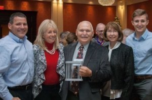 Allyn Anthony, center, with his family after he was honored with the Michigan State Horticultural Society's Distinguished Service Award for his service to the society and overall leadership in the industry at the Great Lakes Fruit and Vegetable and Farm Market Expo in Grand Rapids, Michigan, on December 6, 2017 (Kate Prengaman/Good Fruit Grower)