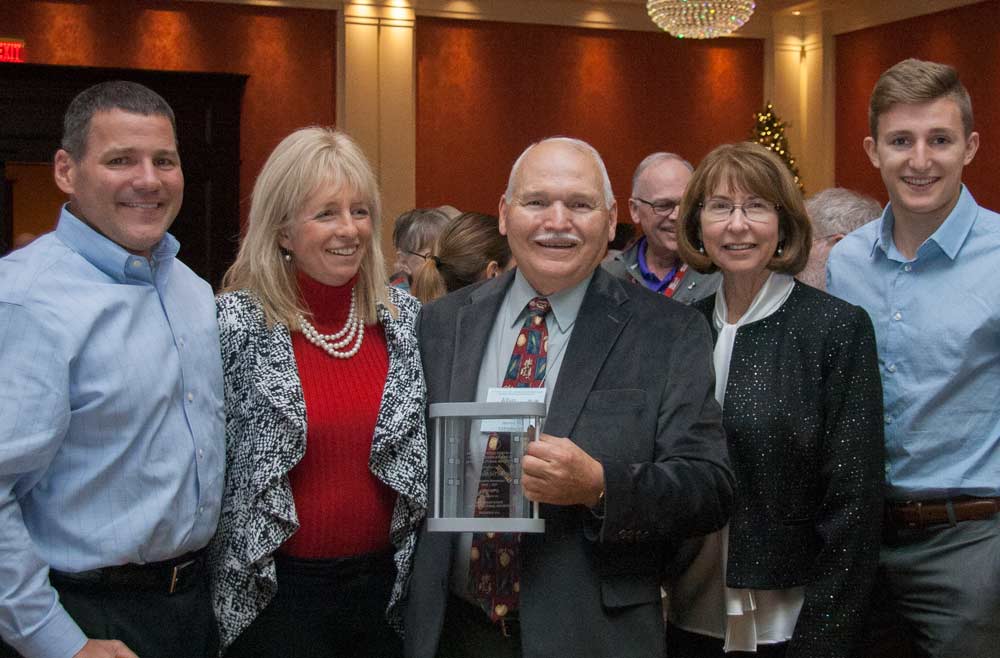 Allyn Anthony, center, with his family after he was honored with the Michigan State Horticultural Society's Distinguished Service Award for his service to the society and overall leadership in the industry at the Great Lakes Fruit and Vegetable and Farm Market Expo in Grand Rapids, Michigan, on December 6, 2017 <b>(Kate Prengaman/Good Fruit Grower)</b>