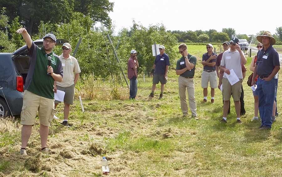 Chris Gottschalk, left, of the Michigan State University Department of Horticulture explains the importance of hard cider variety trials as part of a field day at the Clarksville Research Station in south central Lower Michigan. <b>(by Leslie Mertz)</b>
