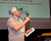 Kevin Judkins of Inland Desert Nursery and Judkins Family Farms gestures toward family members and co-workers as he receives the Grower of the Year Award on Nov. 21 at the Washington State Grape Society Annual Meeting in Grandview. (Ross Courtney/Good Fruit Grower)