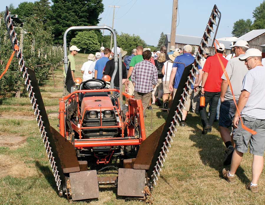 A two-row hedger, designed and built by Paul and Walter Wafler to run down their 7-foot rows between their tall spindle tipped trees, is able to hedge two rows at a time. The machine cuts labor time and costs in half for this task. <b>Dave Weinstock/Good Fruit Grower</b>
