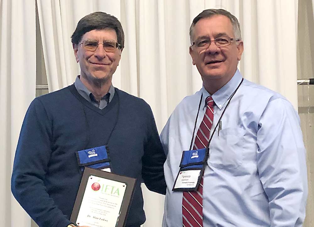 Alan Lakso, left, is presented with the International Fruit Tree Association Outstanding Researcher Award from Terrence Robinson of Cornell University, on Monday, February 25, 2019. (Courtesy Sheri Nolan/IFTA)