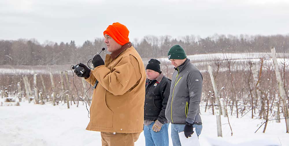 With rolling orchard topography in the background, Cornell University researcher Terence Robinson speaks about soil variability with Andrew Wright of Helena Agri-Enterprises, right, and Bob La Comb of Fowler Farms in February in Rochester, New York. (Ross Courtney/Good Fruit Grower)