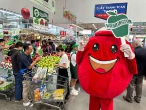 A Washington Apple Commission mascot greets shoppers in the produce section of the MM Mega Market during a promotional event on April 11. Vietnam is the fifth largest export market for Washington apples, according to the commission. (Courtesy Washington State Department of Agriculture)
