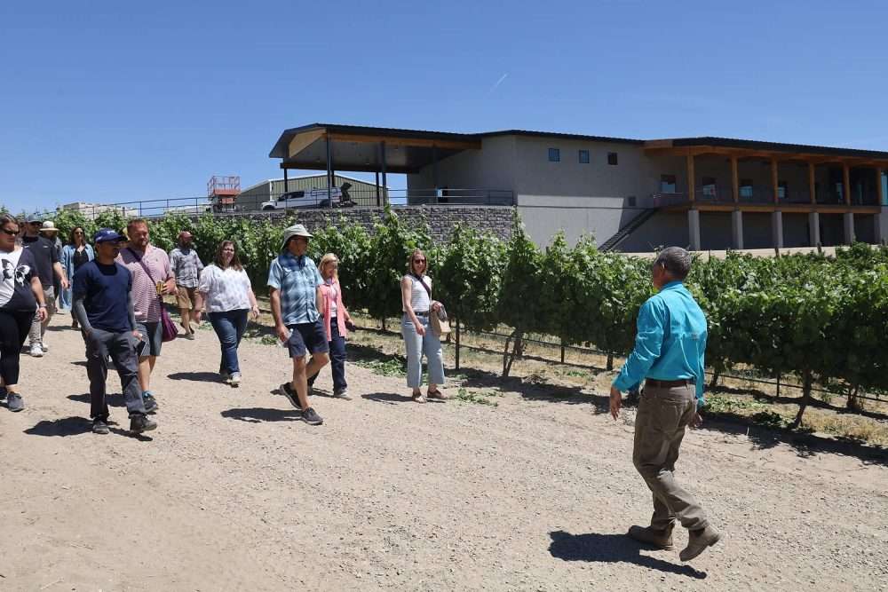 Jay Hawkins leads a tour group from the American Society for Enology and Viticulture through his Sunnyslope, Idaho, vineyard
