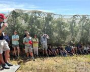 Graeme Krige, left, technical director for the Two-A-Day Group cooperative talks to International Fruit Tree Association tour attendees about the benefits of shade netting for reducing sunburn on apples and pears at Oewerzicht Farm in Greyton, South Africa. (TJ Mullinax/Good Fruit Grower)