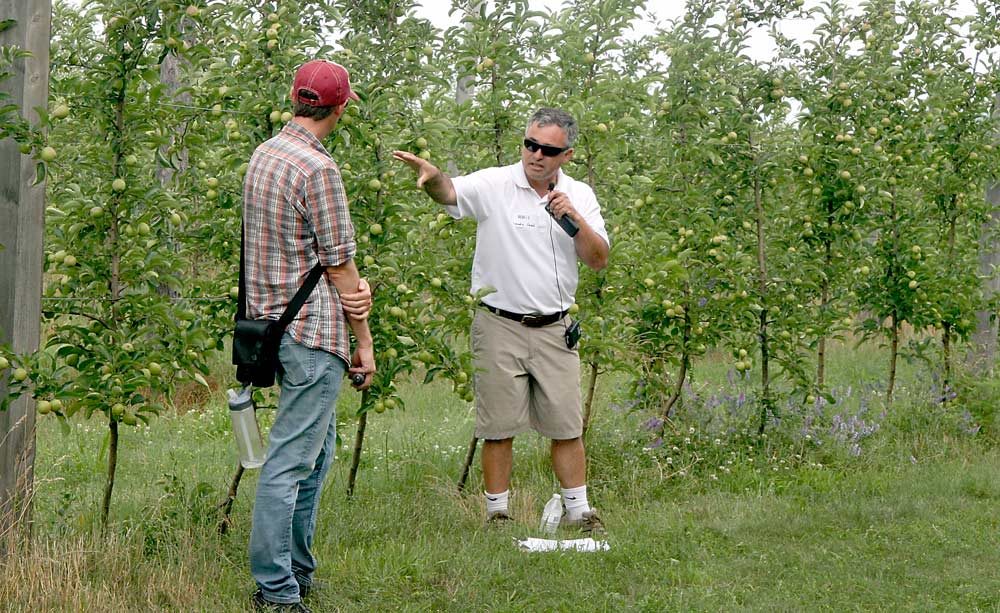 Mario Miranda Sazo, right, and Jaume Lordan, both from Cornell University, discuss the need for irrigation in high-density apple systems in an organic GoldRush block at Bittner-Singer Farm in Appleton, New York. <b>(Kate Prengaman/Good Fruit Grower)</b>
