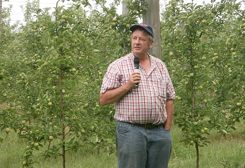 Jim Bittner of Bittner-Singer Orchards talks about finding a profitable home for organic apples for the processing market in front of his organic GoldRush block during the Cornell Cooperative Extension Lake Ontario Fruit Summer Tour. <b>(Kate Prengaman/Good Fruit Grower)</b>