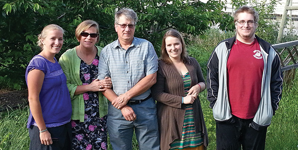 When Keith Carlson (center) was appointed CEO of PICO last summer, his family stepped in to run their Summerland orchard. Pictured with him are (from left) daughter Erin Carlson, wife Jan, daughter Claire Tamang, and son Marten Carlson.