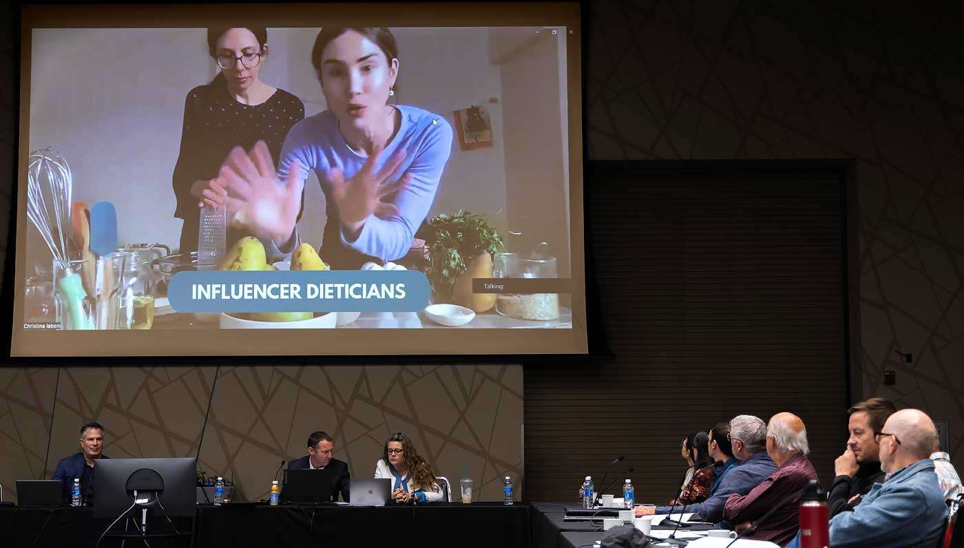 New Pear Bureau Northwest President CarrieAnn Arias, pictured third from left below the screen, shares the success of marketing campaigns in Canada in partnership with two registered dietitians, Elis Halenko and Christina Iobani, during a presentation to the board on promotional activities at the bureau’s annual meeting in Yakima, Washington, on May 14. (Kate Prengaman/Good Fruit Grower)