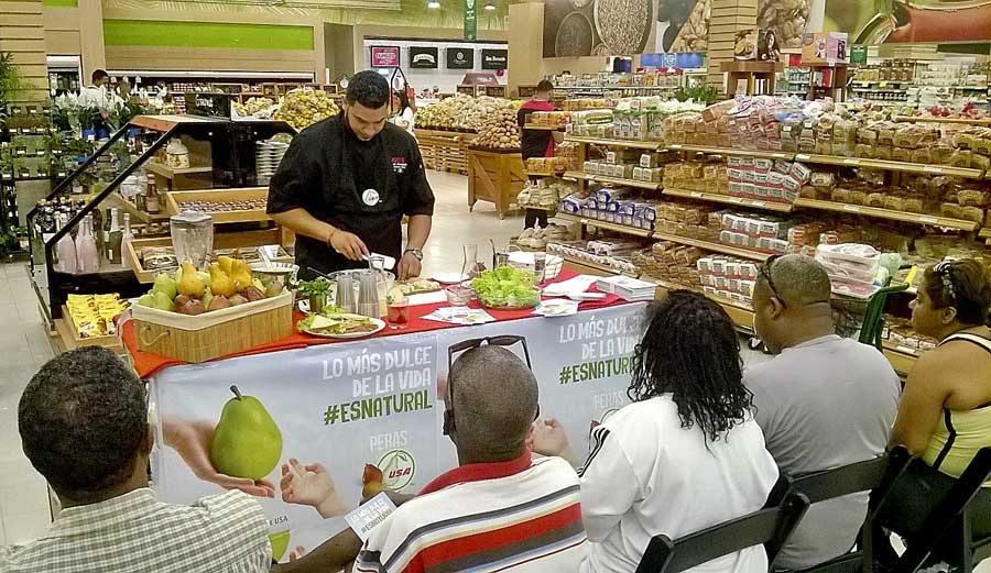 A chef demonstrates recipes using fresh pears at a store in Latin America during a promotion organized by the Pear Bureau Northwest. In a routine vote, growers in Washington and Oregon are being asked to approve continuing the marketing order that allows such generic promotions. <b>(Courtesy Pear Bureau Northwest)</b>