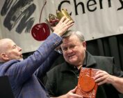 Mike Taylor, left, the 2024 Cherry King, crowns 2025 Cherry King Gary Grove. Grove retired at the end of 2024, after 38 years as a pathologist at Washington State University, where he focused on helping cherry growers manage powdery mildew. (TJ Mullinax/Good Fruit Grower)