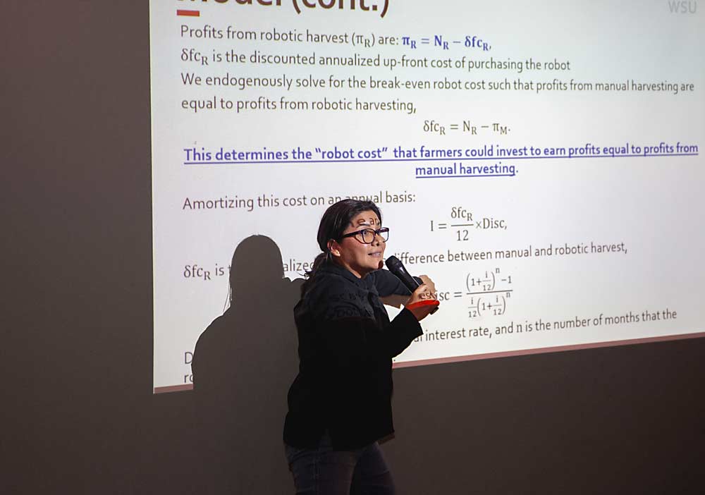 Karina Gallardo, a Washington State University agricultural economist, explains the complex math behind her enterprise budget for harvest robotics at a March industry meeting in Yakima, Washington. (Ross Courtney/Good Fruit Grower)