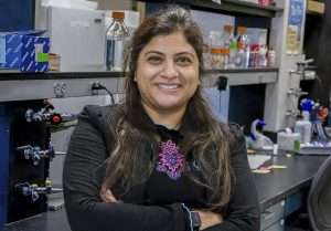 Priya Chakrabarti Basu, Washington State University’s newest bee scientist, poses in a bee research laboratory at the Pullman campus. (Courtesy Janae Becher/Washington State University)