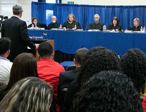 The Washington State Supreme Court listens to attorney Adam Belzberg, left, talk on behalf of Sakuma Bros. Farms’ position about piece rate rest breaks during a public hearing at Heritage University in Toppenish, Washington, on March 17, 2015.(TJ Mullinax/Good Fruit Grower)