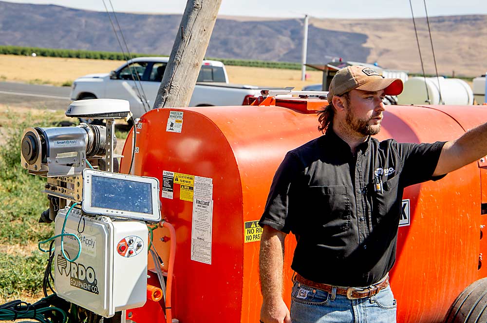 Dave Del Moro of RDO Equipment Co. discusses Smart Apply sprayer automation technology at a field day in August 2023 near Prosser, Washington. (Ross Courtney/Good Fruit Grower)