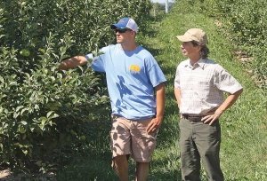 Randy Beaudry outlined the storage protocols he has developed for maintaining Honeycrisp quality. He spoke to growers in orchard operated by Joe, Al, Dan, and Ryan Dietrich near Conklin, Michigan. He and Dan look over the developing Honeycrisp crop. (Richard Lehnert/Good Fruit Grower)