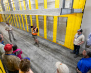 Marius Voigt, operations manager for Fruit2U Packers, gives the International Fruit Tree Association a tour of the forced air “tunnels” that are used to quickly cool pallets of packed stone fruit, table grapes and citrus, depending on the season, at the facility in Wellington, South Africa. (TJ Mullinax/Good Fruit Grower)