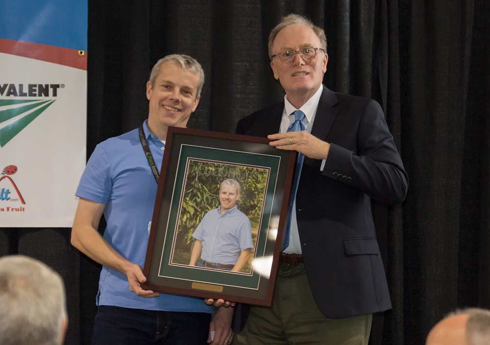 Mike Omeg is honored with the Grower of the Year award during the Washington State Tree Fruit Association 113th Annual Meeting on December 5, 2017. <b>(TJ Mullinax/Good Fruit Grower)</b>
