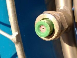 A chipped and worn ceramic spray nozzle