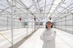 Washington State University entomology department chair Laura Lavine stands inside a greenhouse at the site where the WSU honeybee research program will be moving. (Courtesy Washington State University)