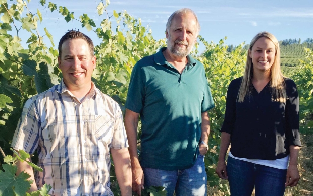 Lacey Lybeck (right) is taking over as vineyard manager at Sagemoor Farms from Derek Way (left), who is going to live in China. They are pictured with Kent Waliser, director of vineyard operations, who said Way has been dedicated to improving the vineyards during his seven years with Sagemoor. (Courtesy of Sagemoor Vineyards)