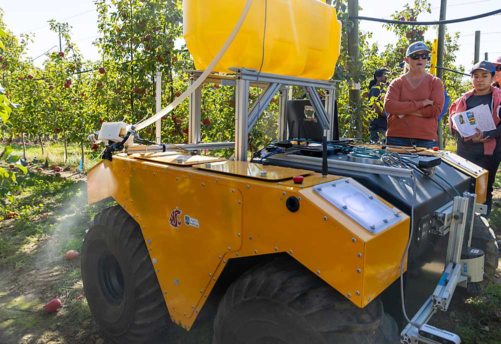 A robotic fertilizer applicator sprays liquid nitrogen on tree roots during a September 2023 demonstration at an AgAID Institute field day at the Washington State University Sunrise Orchard near Wenatchee. (Kate Prengaman/Good Fruit Grower)