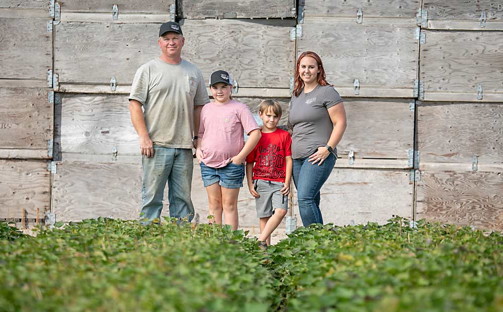 Always on the lookout for opportunities to diversify, the Arnold family — Craig, Addisyn, Tavin and Amanda, from left to right — raises sweet potatoes, wine grapes, almonds and, most recently, pomegranates, along with peaches. (TJ Mullinax/Good Fruit Grower)