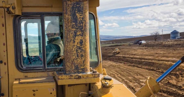 Joe Dobson operates a large bulldozerin Kittitas, Wash., on March 3, 2016 for Washington Fruit & Produce Company. The project site for the new orchard includes the land stretching off in the distance. <b>(TJ Mullinax/Good Fruit Grower)</b>