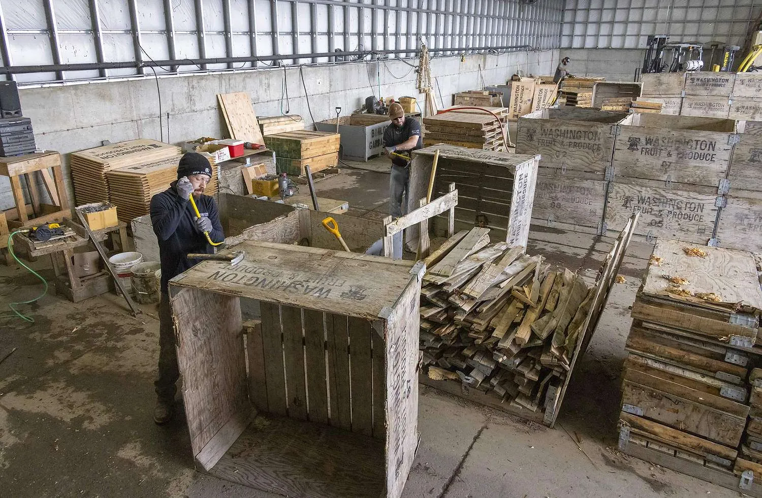 Washington Fruit Growers employees repair wooden bins