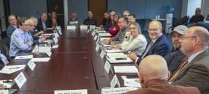 Washington Gov. Bob Ferguson, left, listens to growers and tree fruit industry officials during a roundtable meeting, held in October in Wenatchee