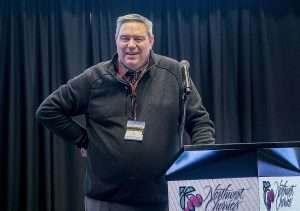 B.J. Thurlby speaks at the 81st Annual Cherry Institute in Yakima, Washington, in January 2024. Thurlby, who died Jan. 10 following surgery for cancer, hosted the meeting for 25 years as president of the Washington State Fruit Commission, a role he retired from in December. (TJ Mullinax/Good Fruit Grower)