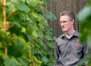 Clean Plant Center Northwest director Scott Harper is surrounded by fruit trees at the Prosser, Washington, center in August 2017. (TJ Mullinax/Good Fruit Grower)