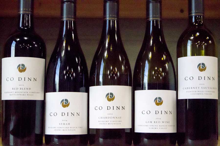 Five bottles of wine, made from grapes representing several Washington vineyards and representing the winery’s five labels, await pouring at Co Dinn Winery. <b>(Shannon Dininny/Good Fruit Grower)</b>