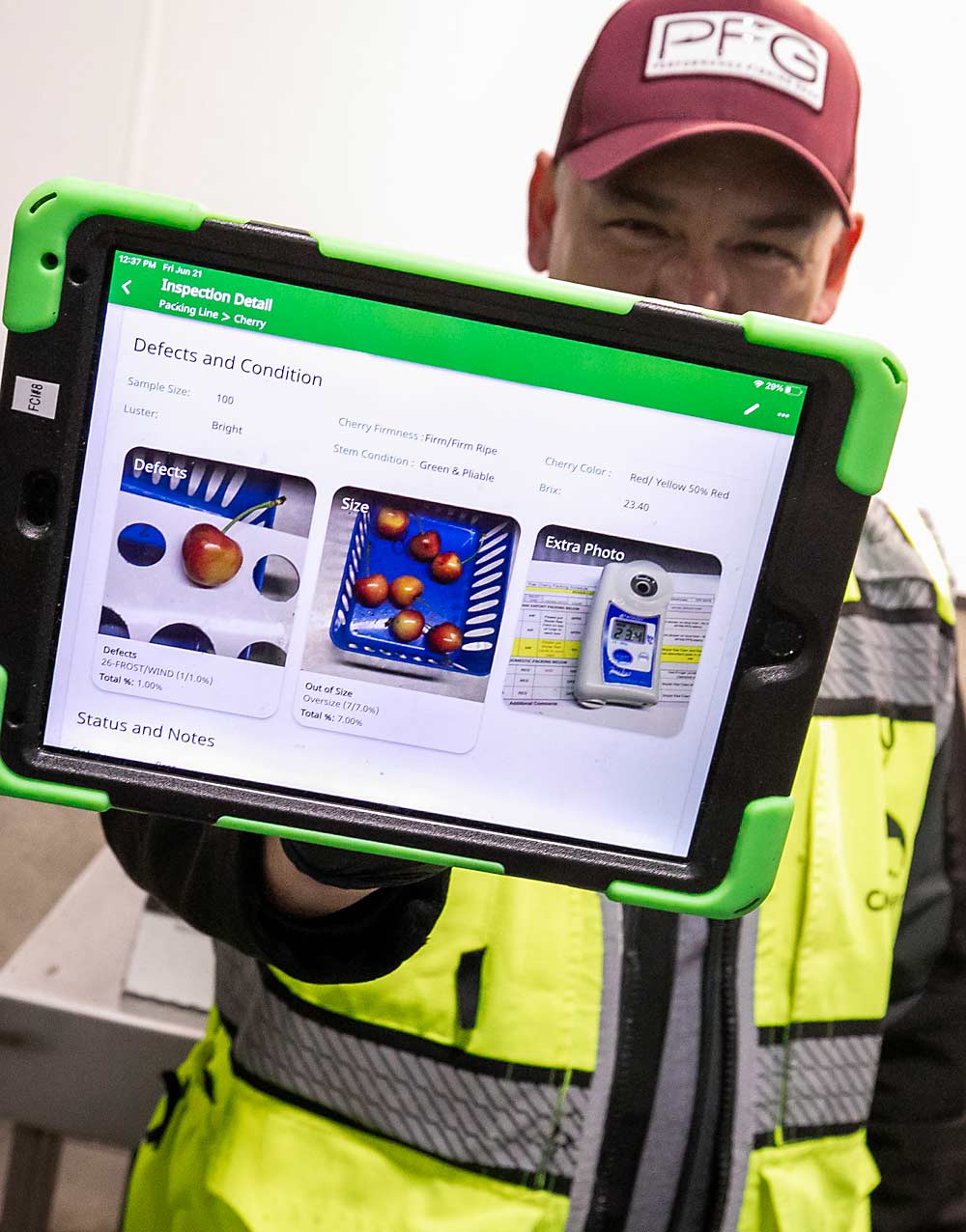 Francisco Velazquez of CMI Orchards, the sales partner to Columbia Fruit Packers, shows the FreshCloud platform at the station where CMI inspects the packaged product. (TJ Mullinax/Good Fruit Grower)