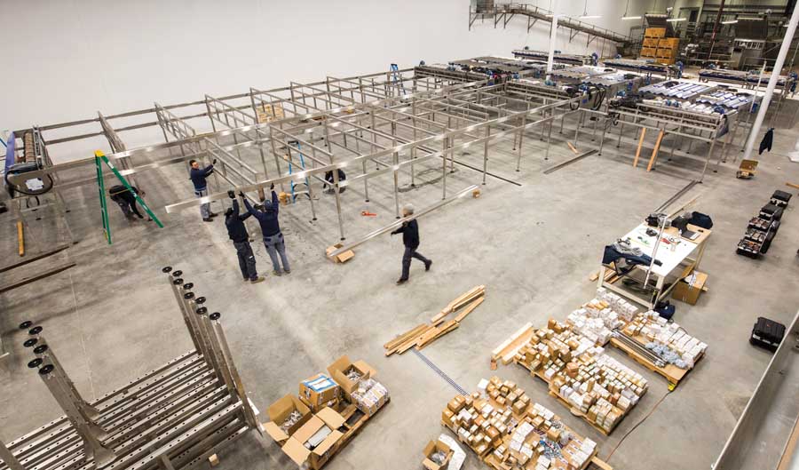 Workers install a cherry processing line that will feature optical equipment to sort fruit at The Dalles Fruit Co. in Dallesport, Washington, on January 13, 2016. <b>(TJ Mullinax/Good Fruit Grower)</b>